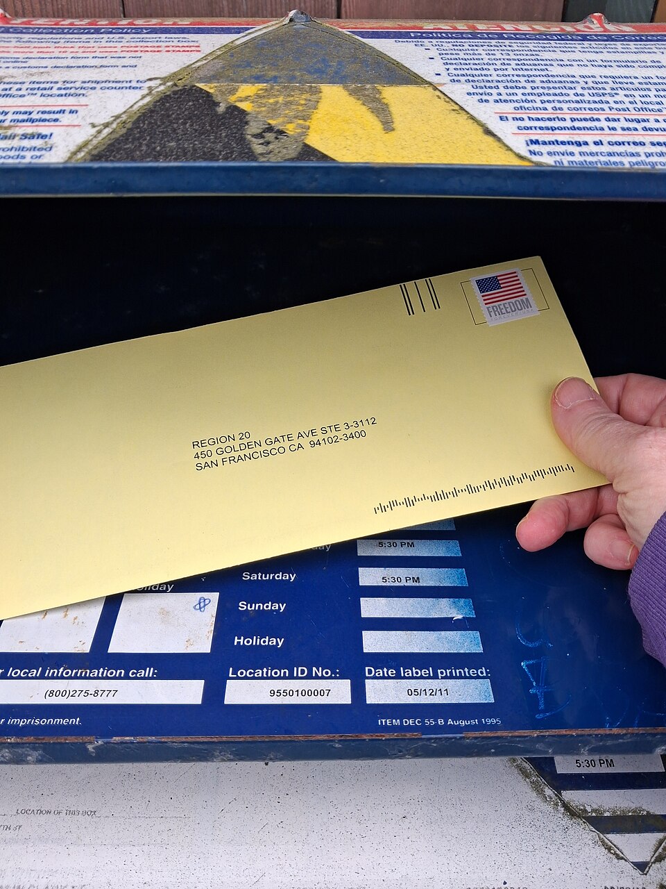 An NLRB union certification mail ballot envelope being placed into a U.S. mailbox